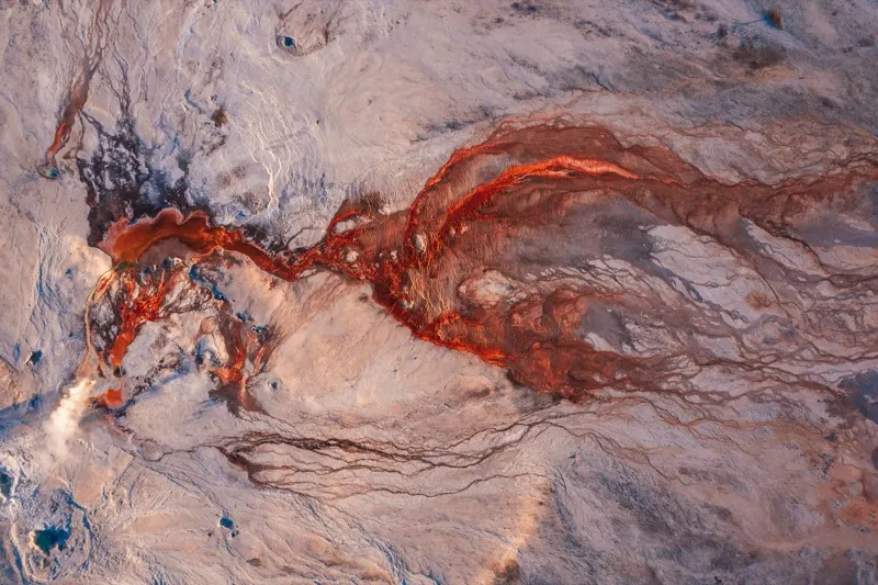 Braided river delta cutting through pale rock
