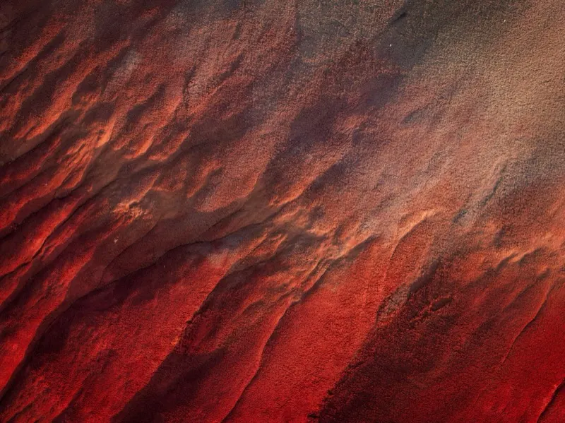 Wind-carved red rock ridges photographed from the air
