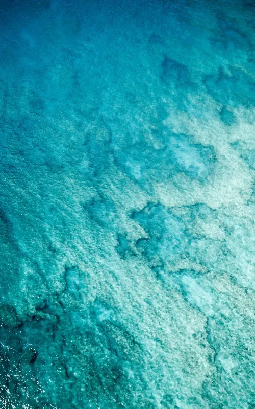 Turquoise coastal water seen from above